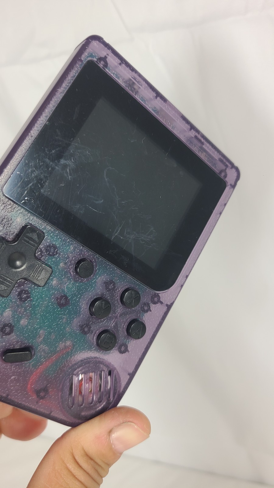 Merkury Innovations Arcade Fun Portable Game Console in a transparent purple…