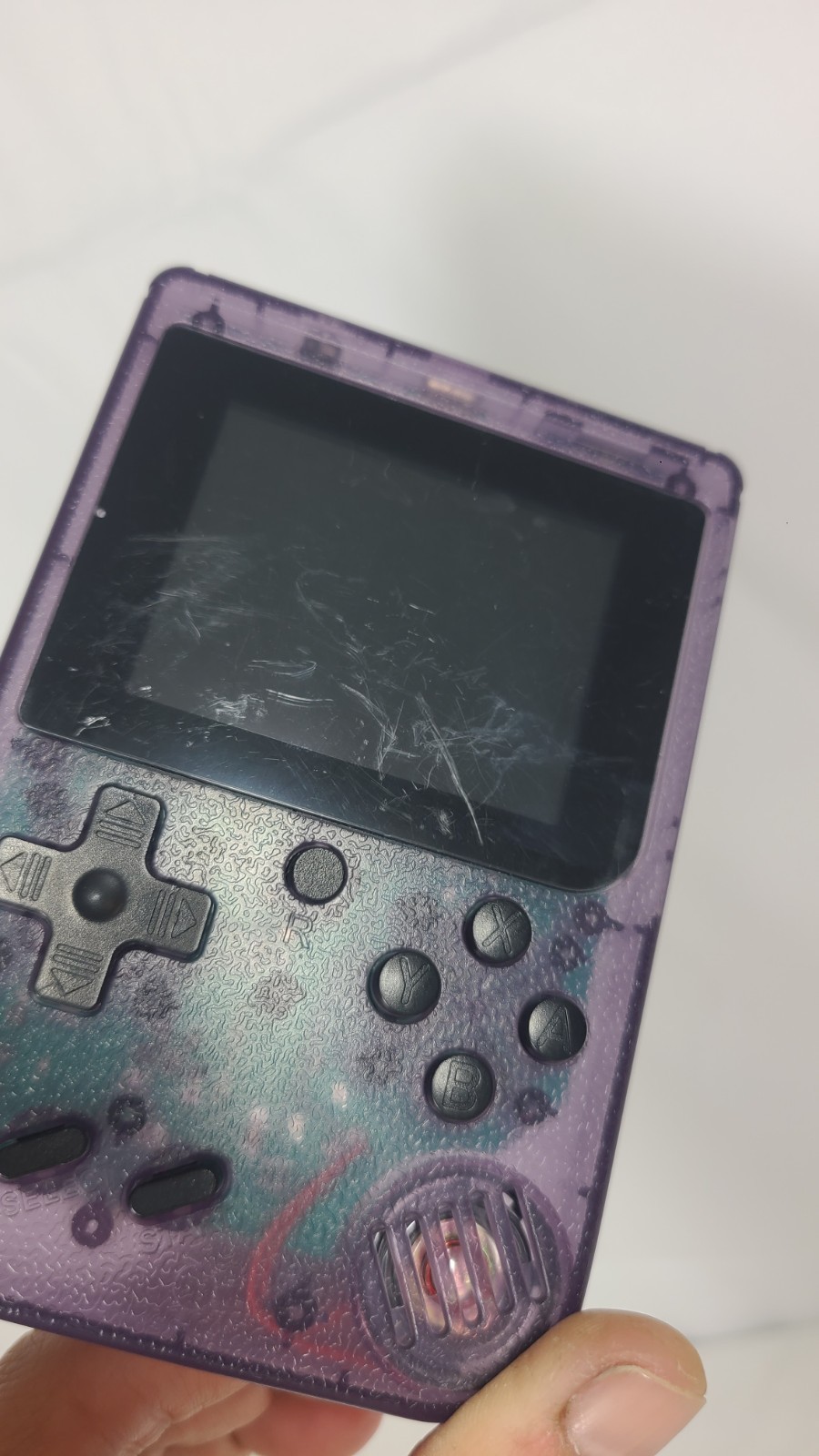 Merkury Innovations Arcade Fun Portable Game Console in a transparent purple…