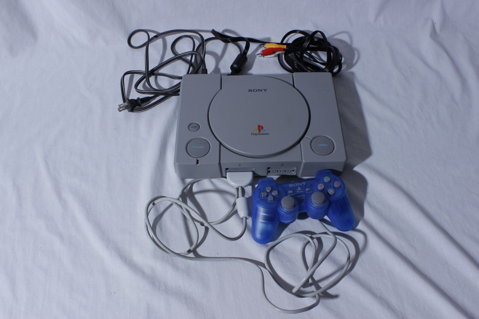Sony Playstation 1 Gray Console With Blue Sony Controller, A/V Cable, and Power