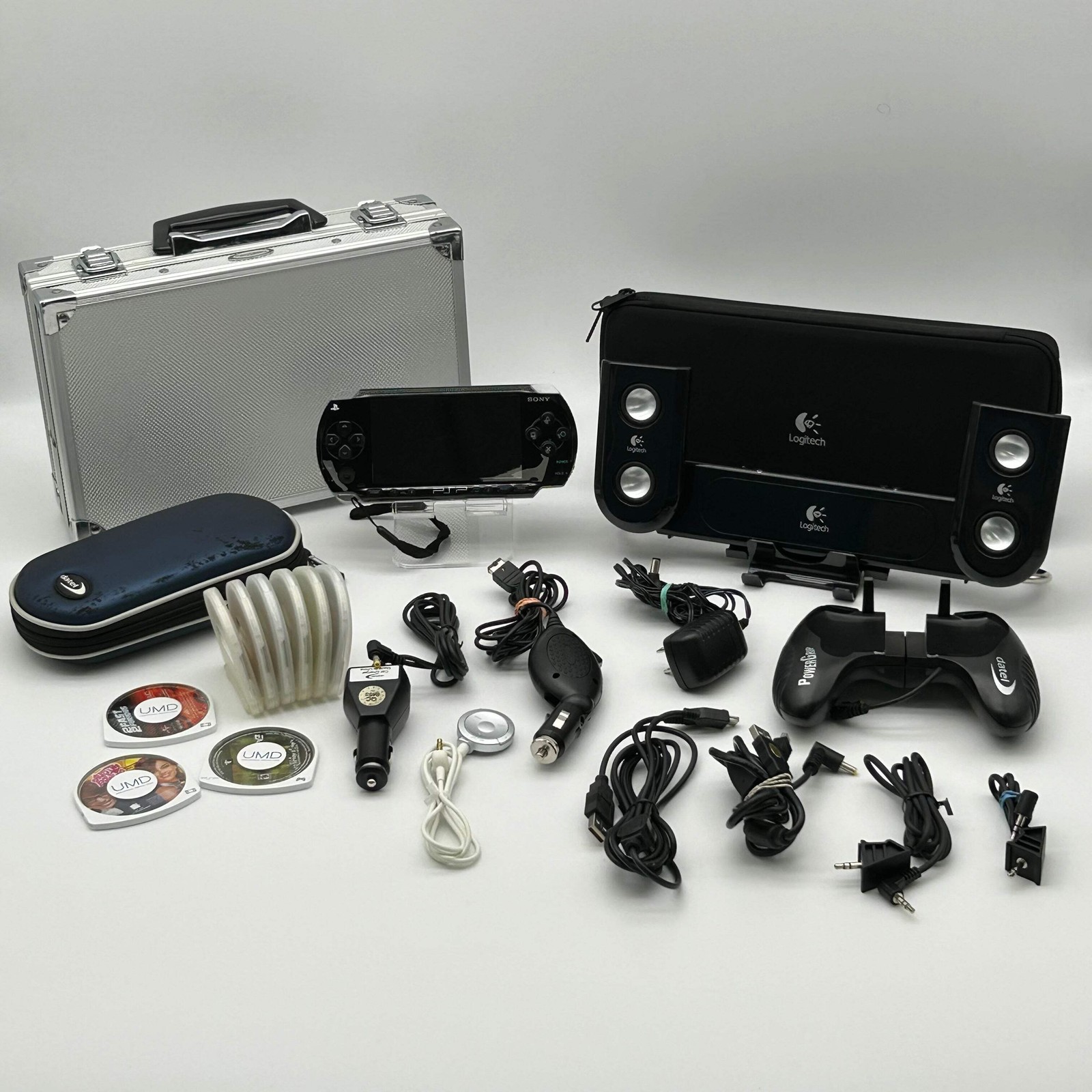Sony PSP 1001 – 9 Game Bundle | Logitech Amp | Tested / Needs Battery – Used