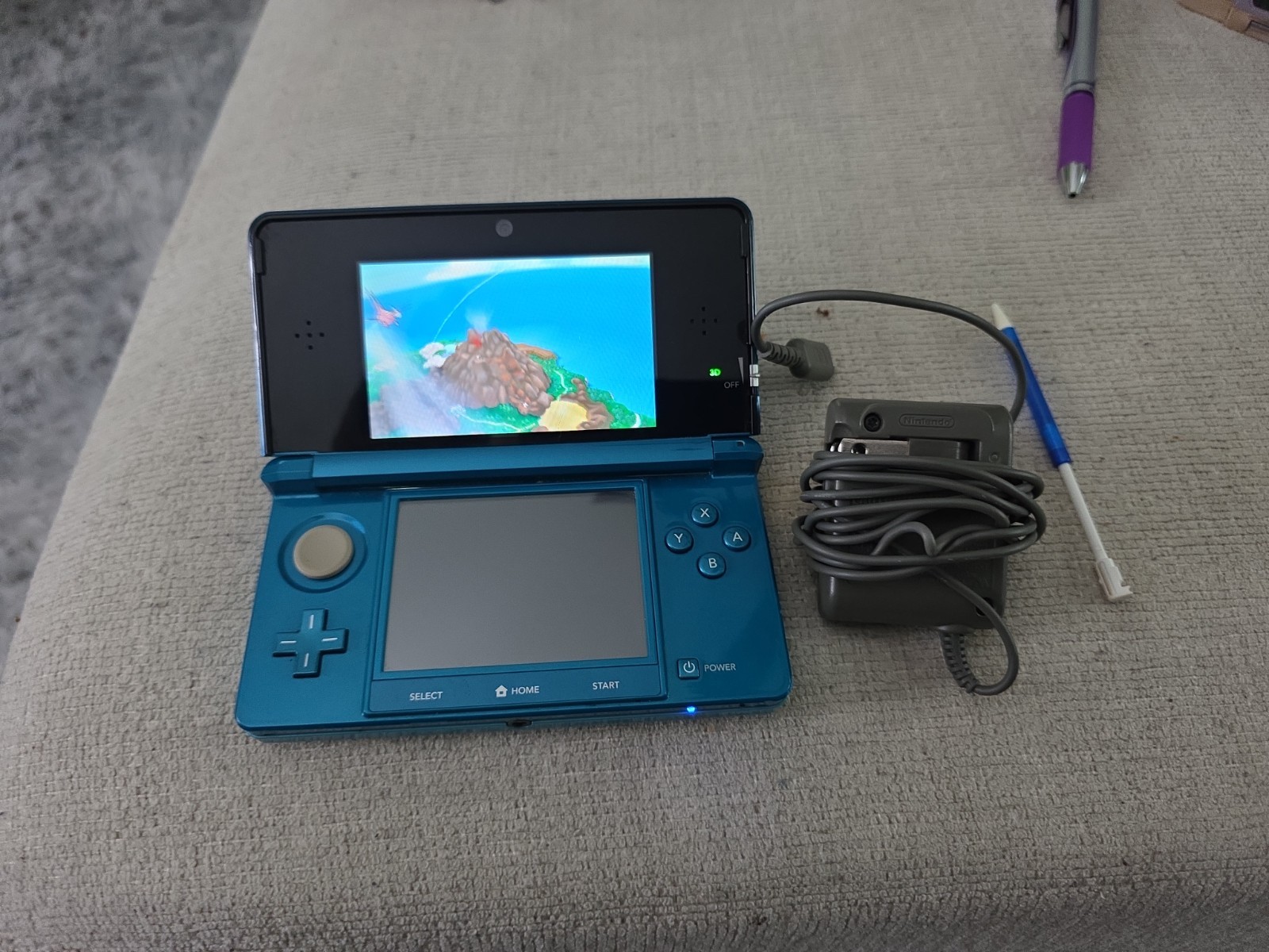 Nintendo 3DS 2GB Aqua Blue Handheld W/Charger, Stylus, & Pokemon Alpha Sapphire