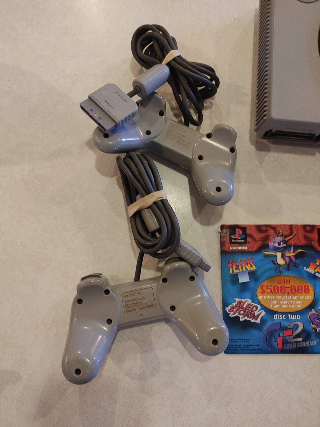 Sony PlayStation Console with two controllers and games