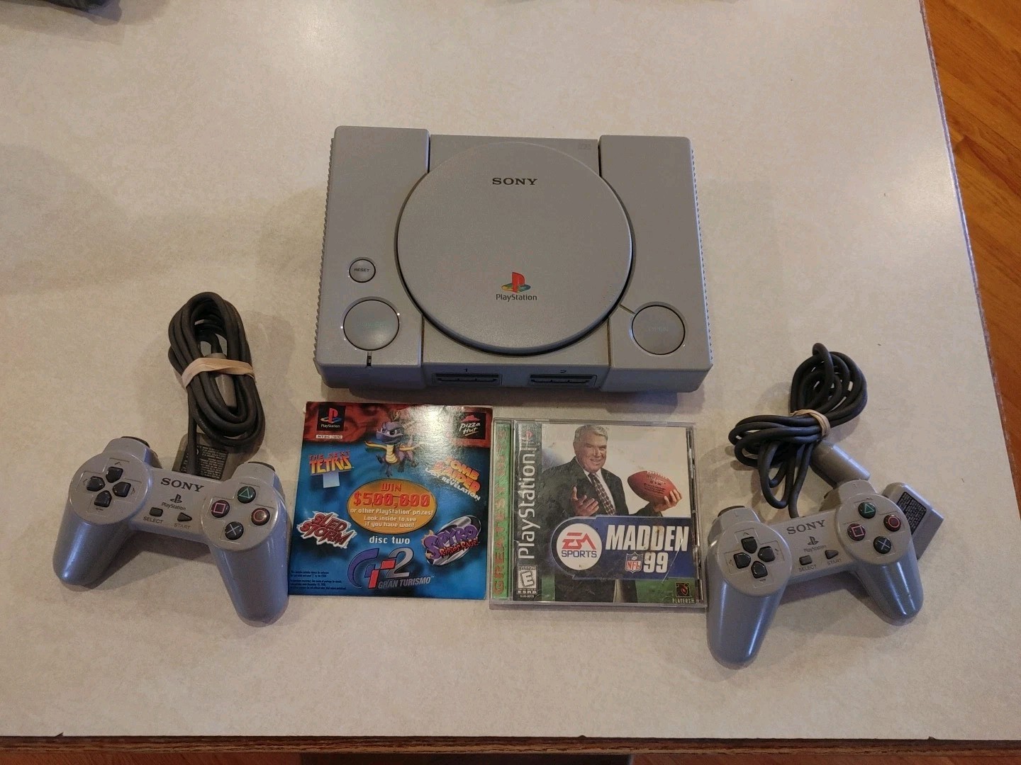 Sony PlayStation Console with two controllers and games