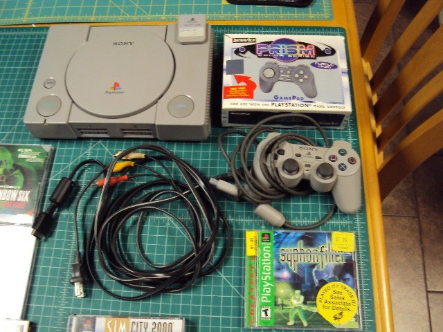 Sony Playstation 1 console bundle with 6 games .
