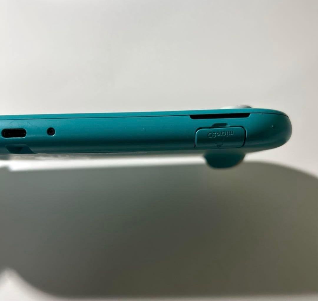 Nintendo Switch Lite Turquoise console with charger light blue
