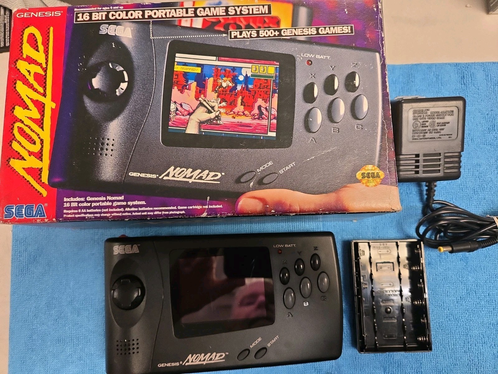 Sega Nomad Console. With Box (no inserts). A/C adaptor. Battery holder missing..