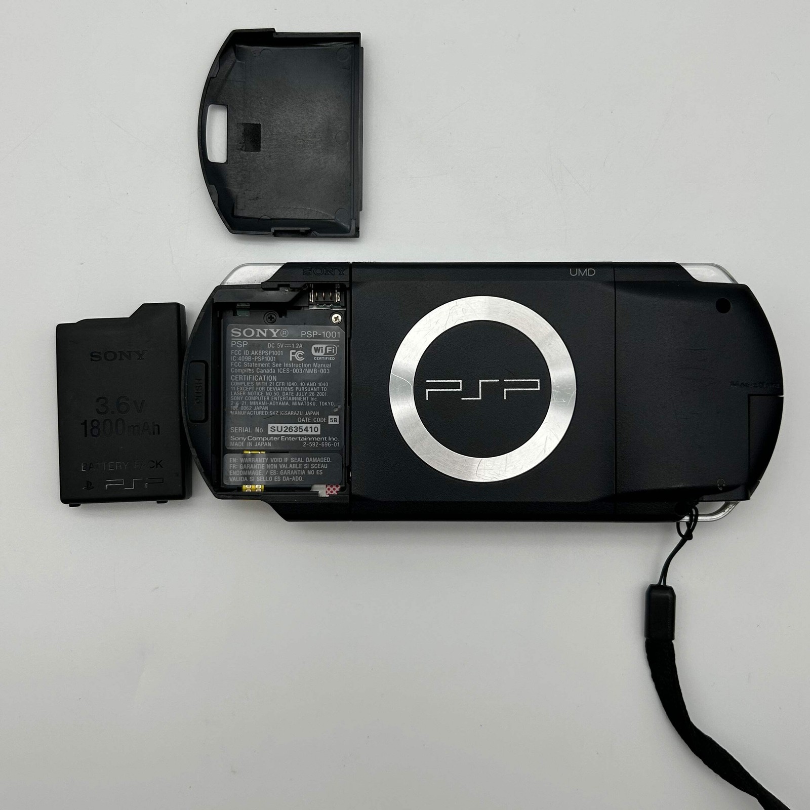 Sony PSP 1001 – 9 Game Bundle | Logitech Amp | Tested / Needs Battery – Used