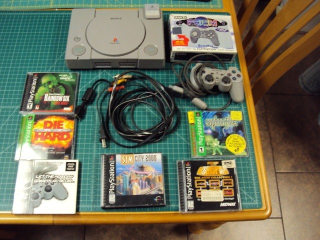 Sony Playstation 1 console bundle with 6 games .