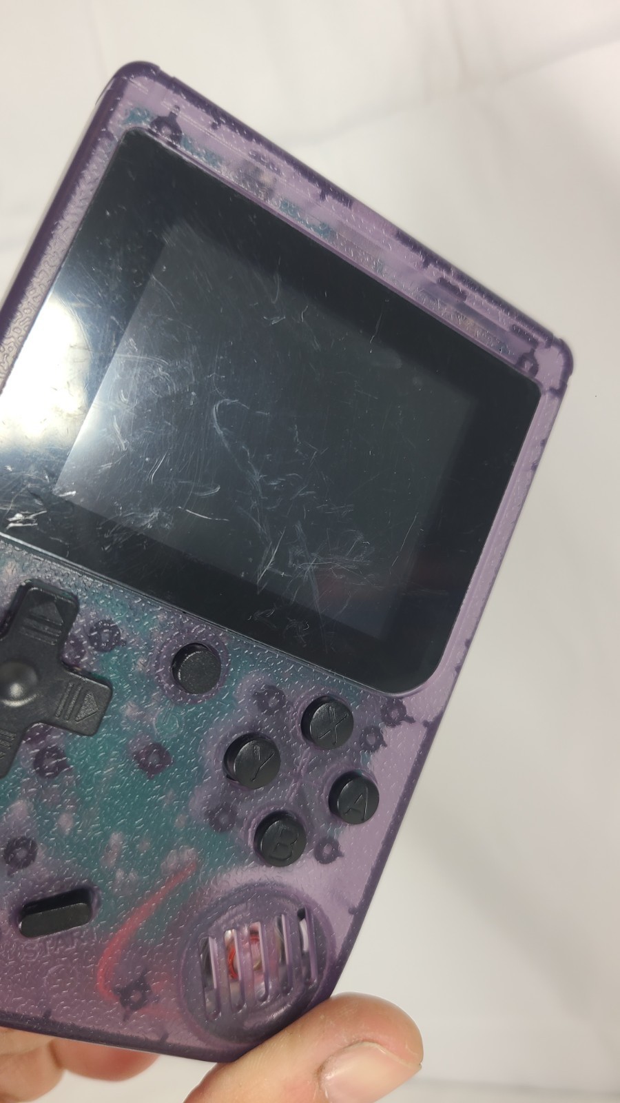 Merkury Innovations Arcade Fun Portable Game Console in a transparent purple…