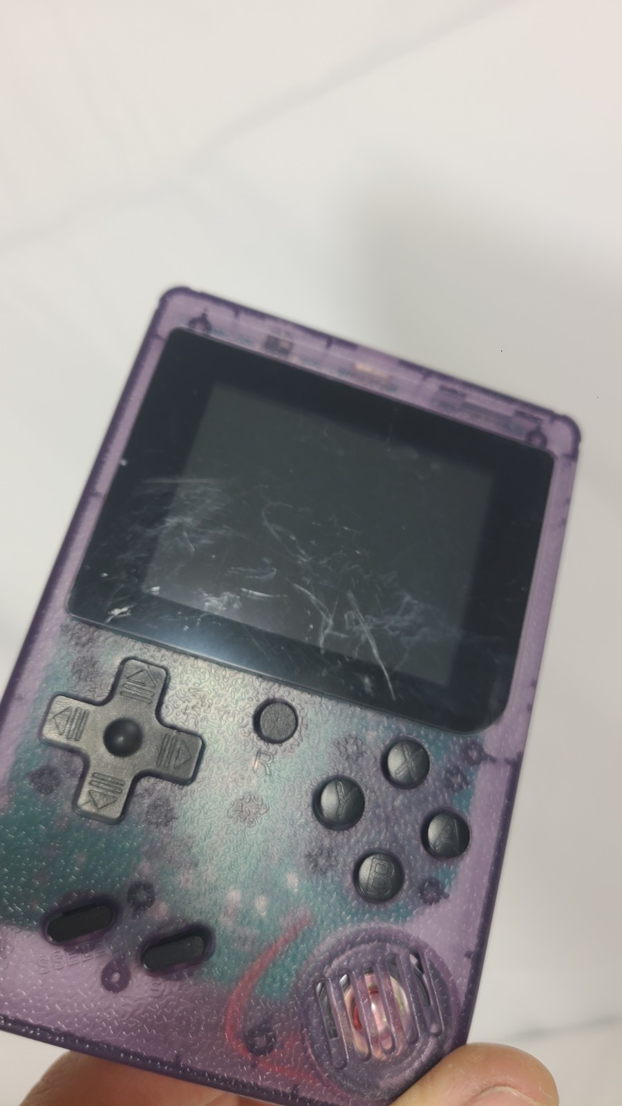 Merkury Innovations Arcade Fun Portable Game Console in a transparent purple…