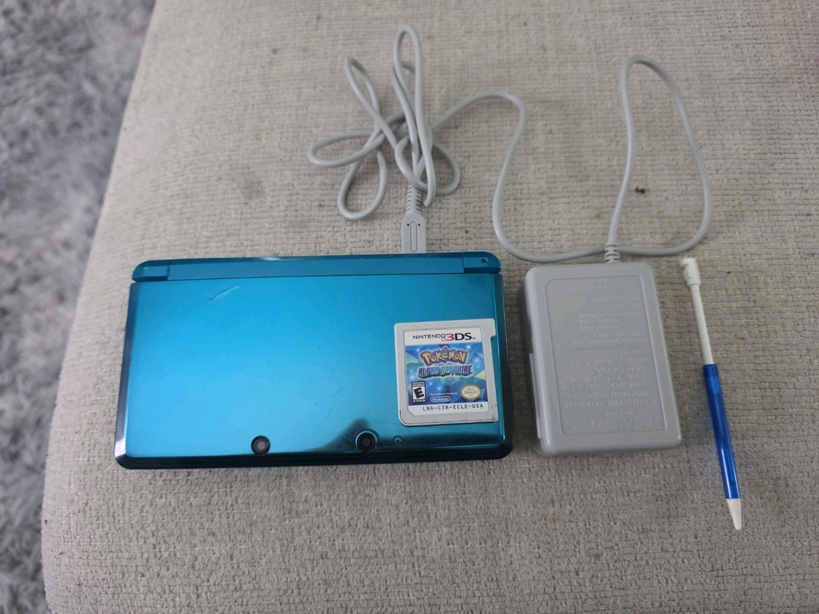 Nintendo 3DS 2GB Aqua Blue Handheld W/Charger, Stylus, & Pokemon Alpha Sapphire