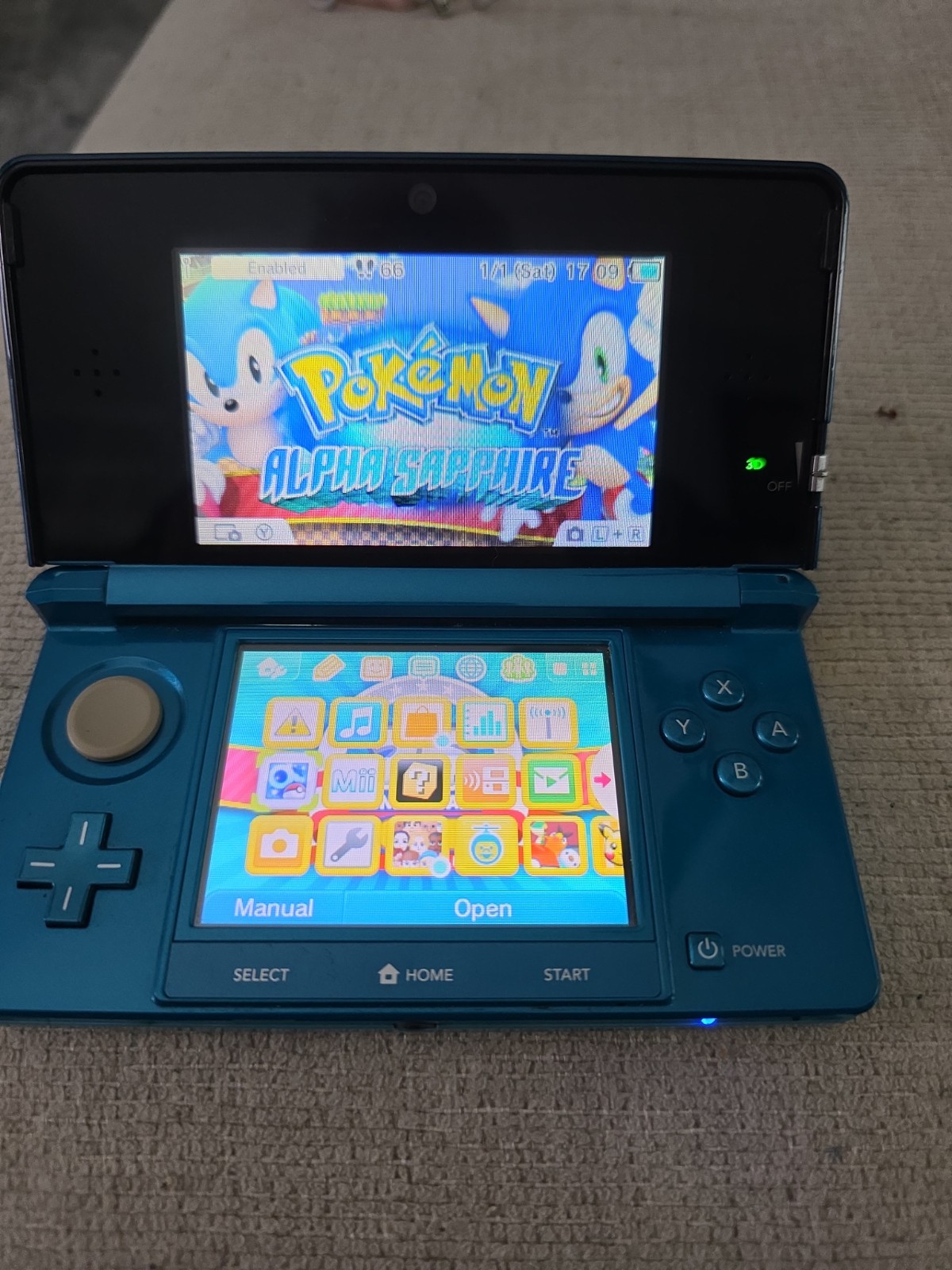 Nintendo 3DS 2GB Aqua Blue Handheld W/Charger, Stylus, & Pokemon Alpha Sapphire