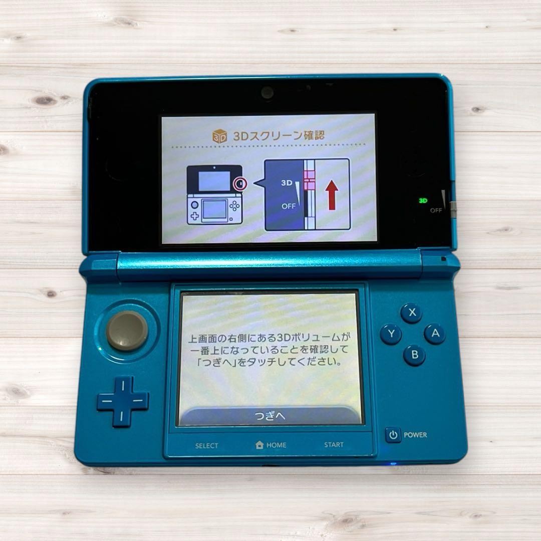 Nintendo 3DS console (Light Blue/Aqua Blue) with charger and stylus included.