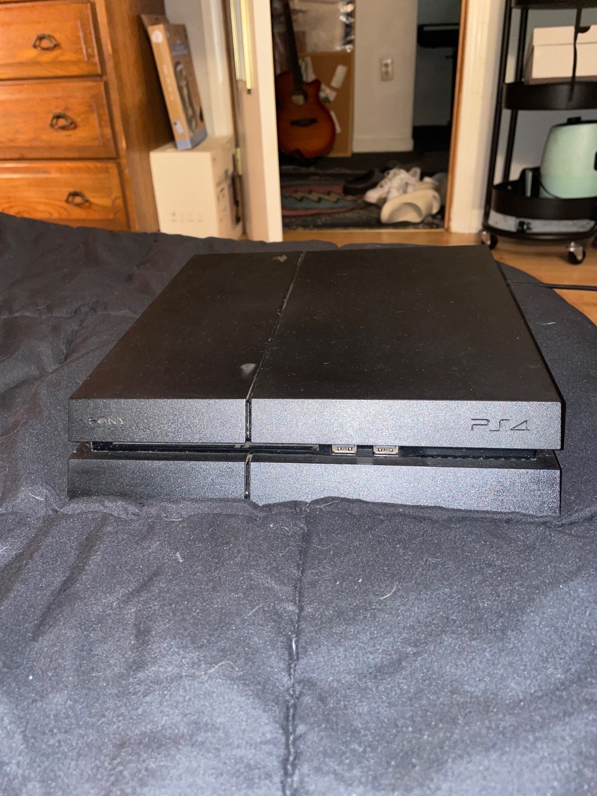 ps4 console with cords, 3 controllers, and wall mount
