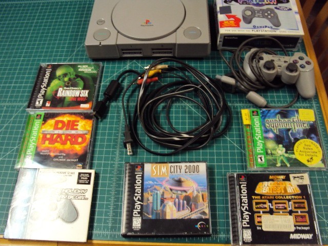 Sony Playstation 1 console bundle with 6 games .