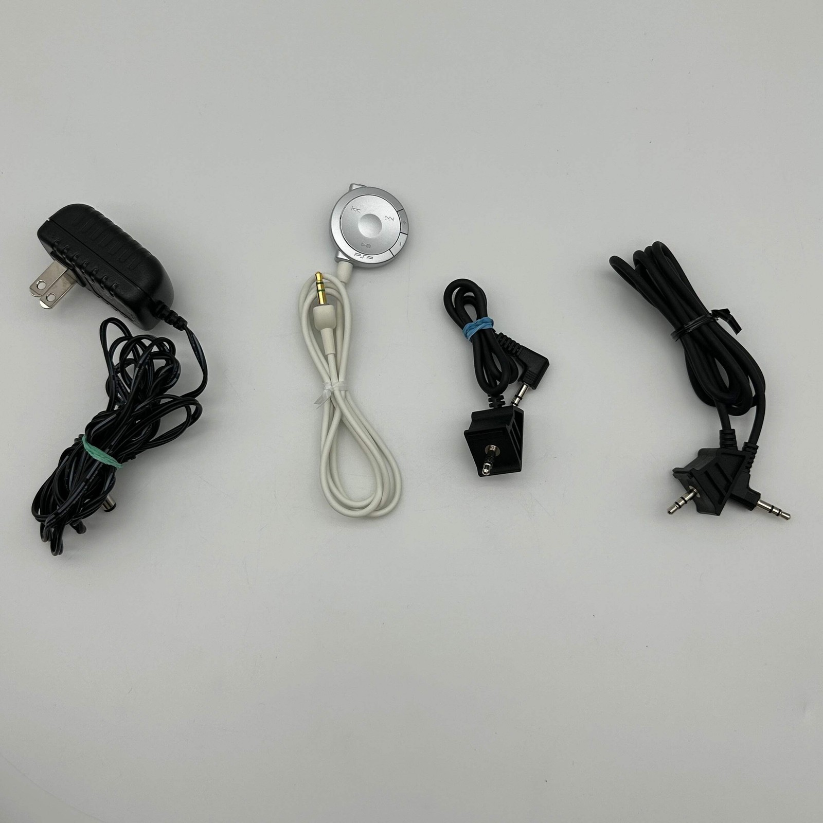 Sony PSP 1001 – 9 Game Bundle | Logitech Amp | Tested / Needs Battery – Used