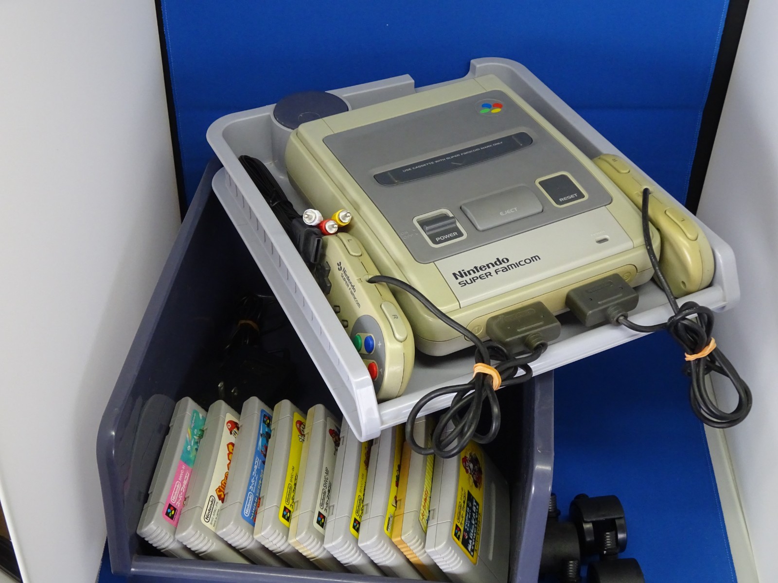 SNES case for Super Mario Kart, Super Mario World, and Super Picross.SNES shelf