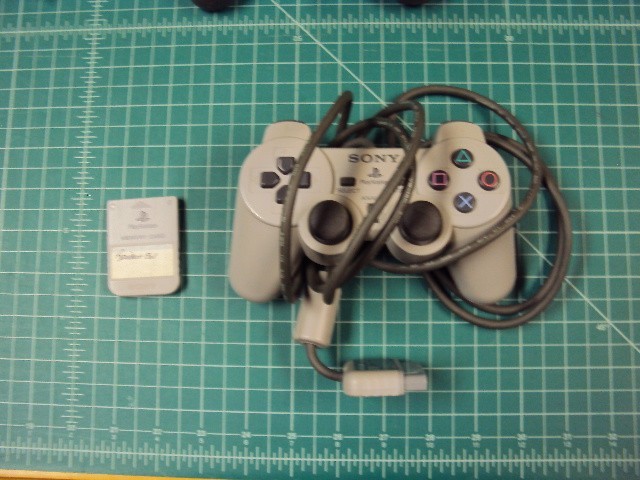 Sony Playstation 1 console bundle with 6 games .