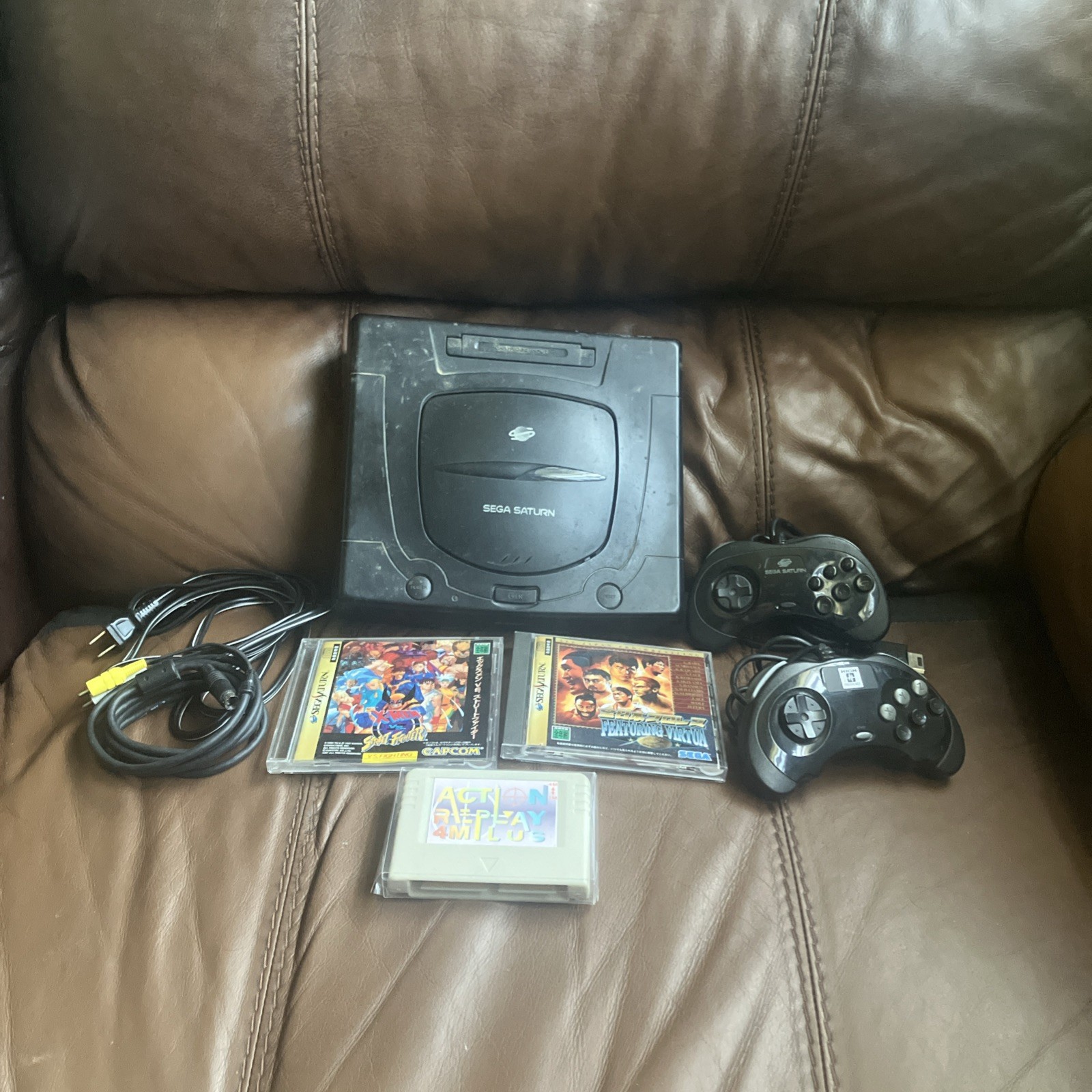 Sega Saturn Console, 2 controllers, 2 games & Action Replay Plus 4M cartridge