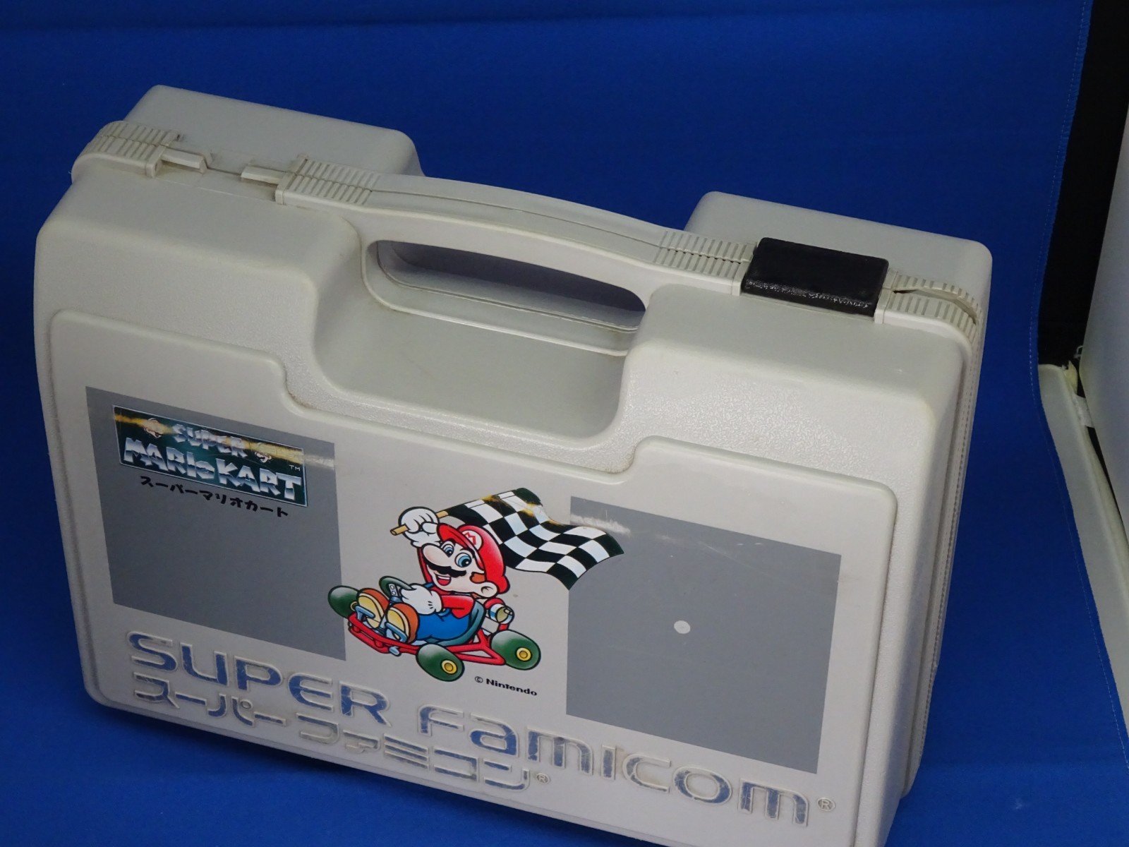 SNES case for Super Mario Kart, Super Mario World, and Super Picross.SNES shelf