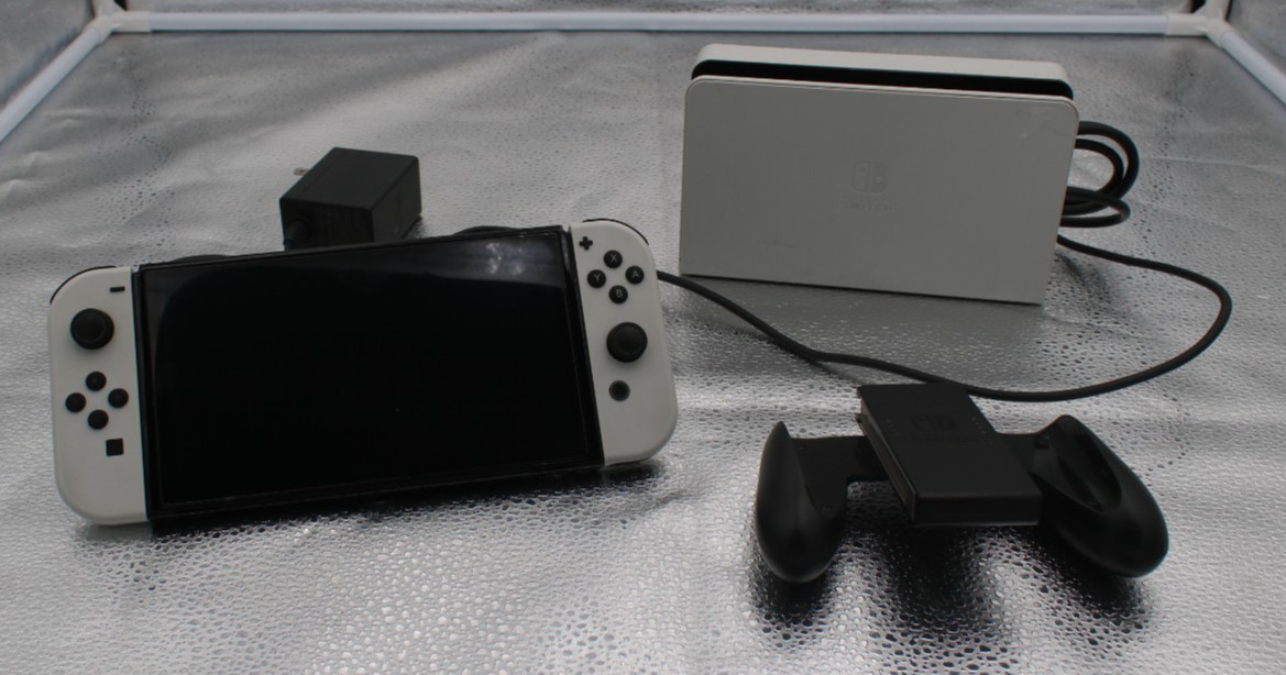 Nintendo Switch OLED Console 64GB w/ dock, cords, and JC holder *factory reset