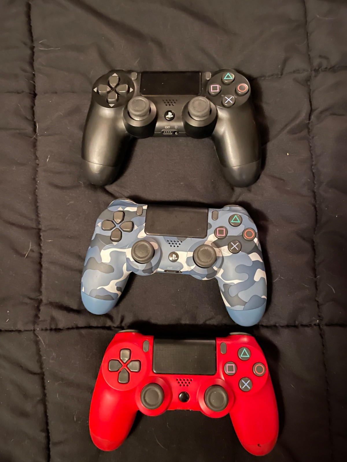 ps4 console with cords, 3 controllers, and wall mount