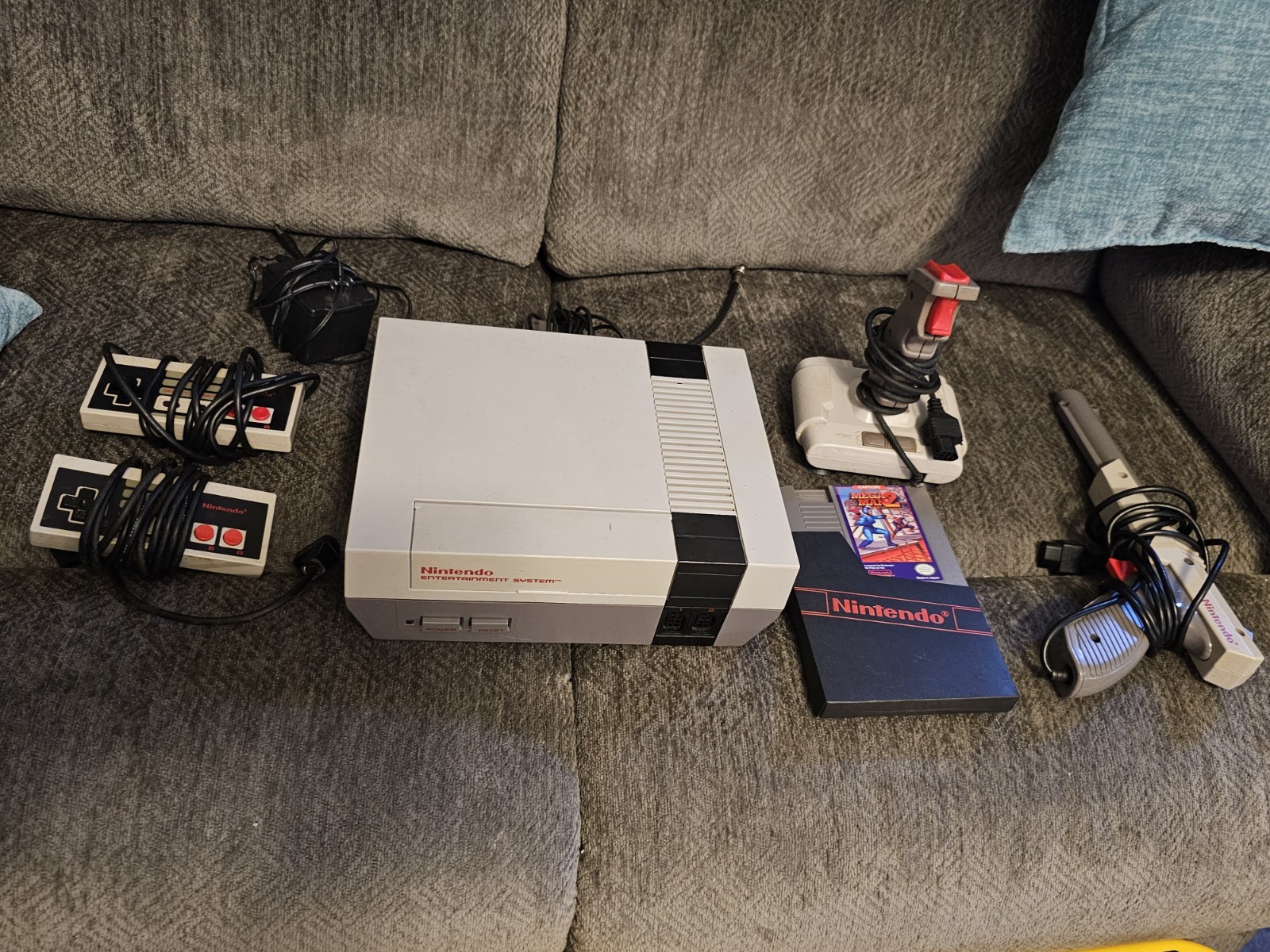 Original NES Console With Controllers, Hookups, Guns, Joysticks And Mega Man 2
