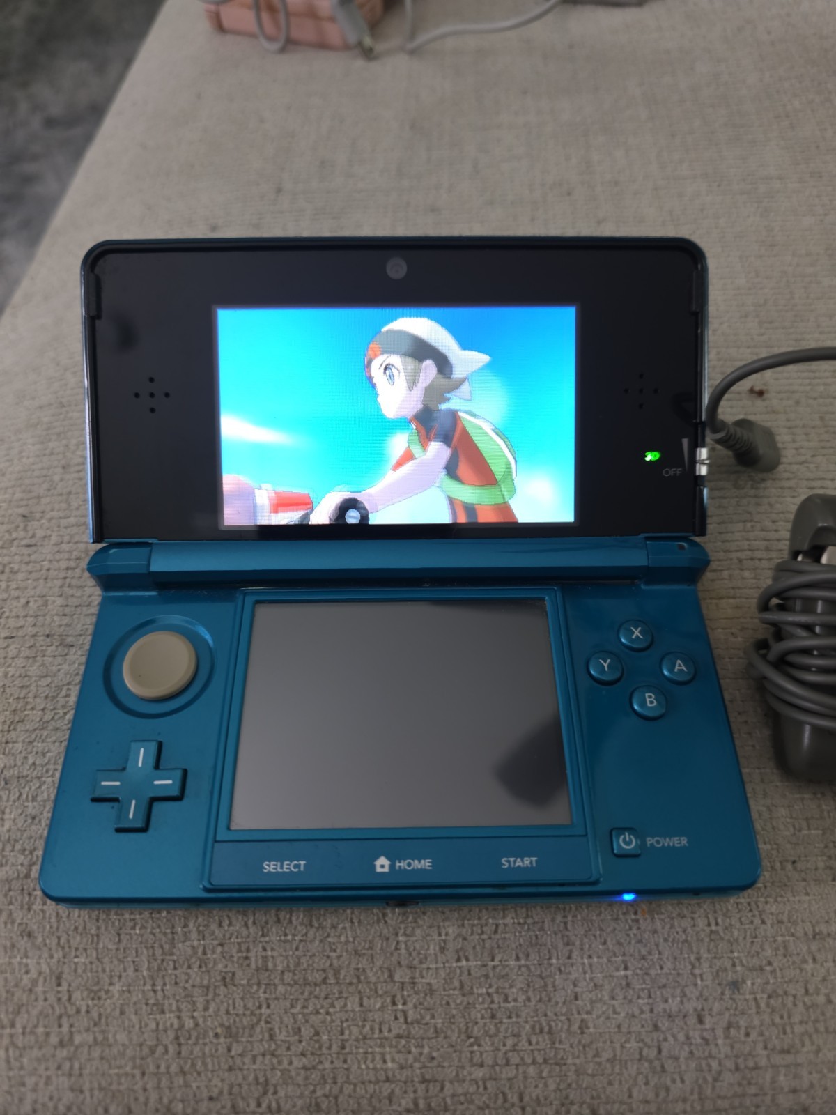 Nintendo 3DS 2GB Aqua Blue Handheld W/Charger, Stylus, & Pokemon Alpha Sapphire