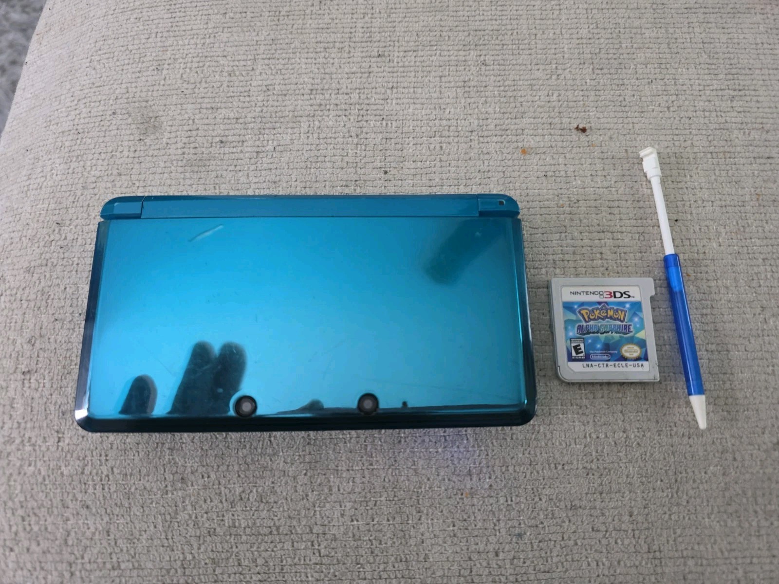 Nintendo 3DS 2GB Aqua Blue Handheld W/Charger, Stylus, & Pokemon Alpha Sapphire