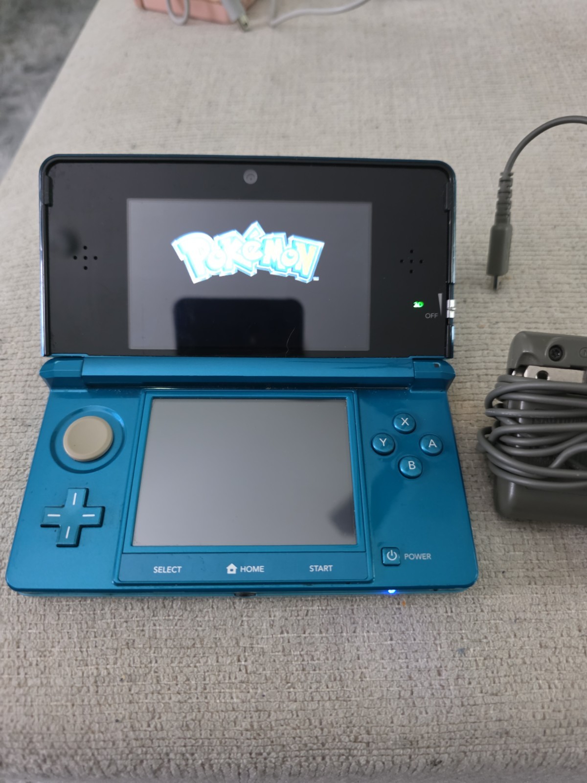 Nintendo 3DS 2GB Aqua Blue Handheld W/Charger, Stylus, & Pokemon Alpha Sapphire