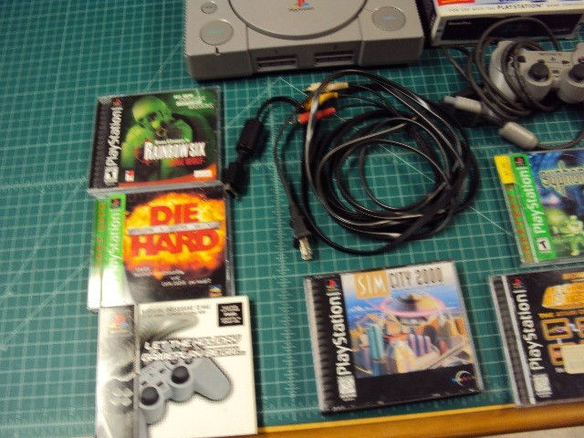 Sony Playstation 1 console bundle with 6 games .