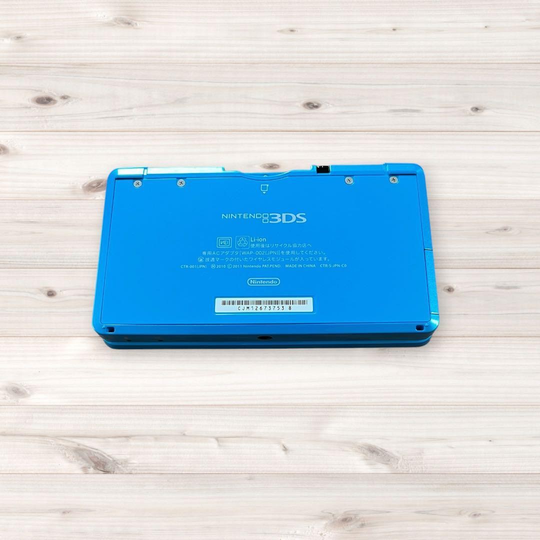 Nintendo 3DS console (Light Blue/Aqua Blue) with charger and stylus included.