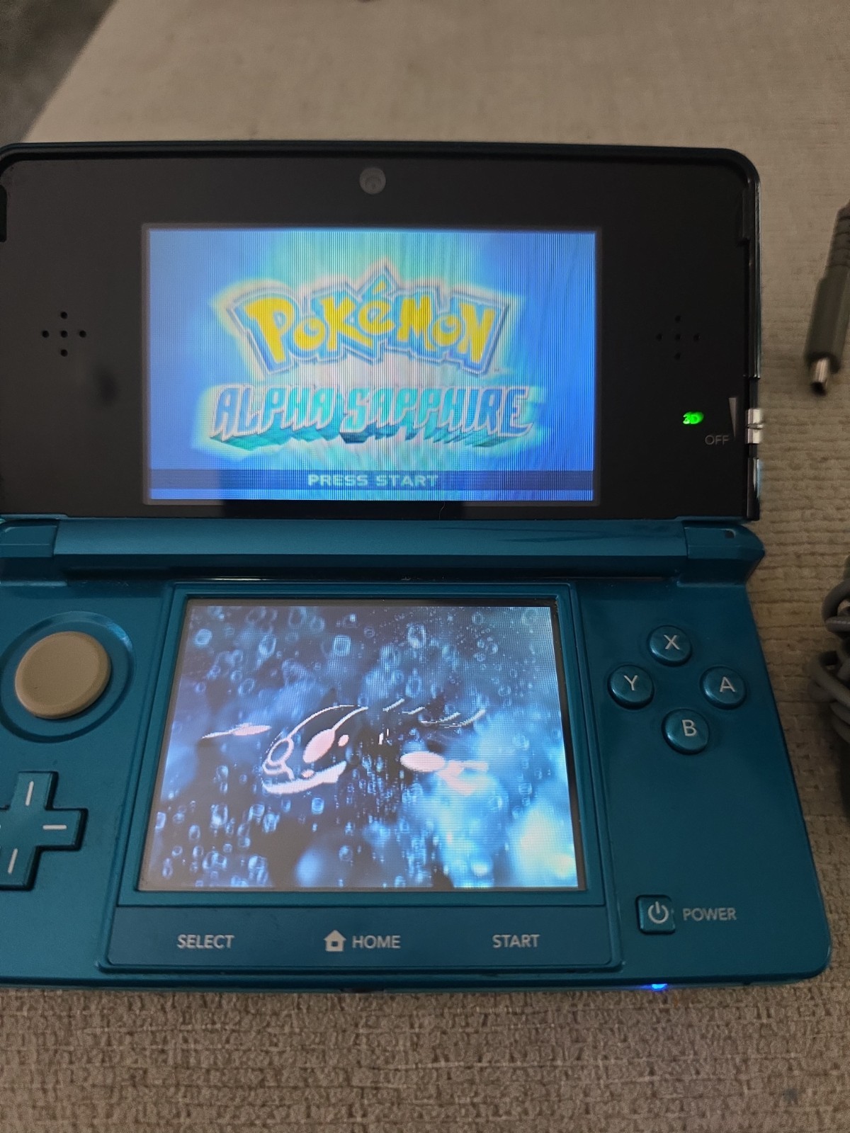 Nintendo 3DS 2GB Aqua Blue Handheld W/Charger, Stylus, & Pokemon Alpha Sapphire
